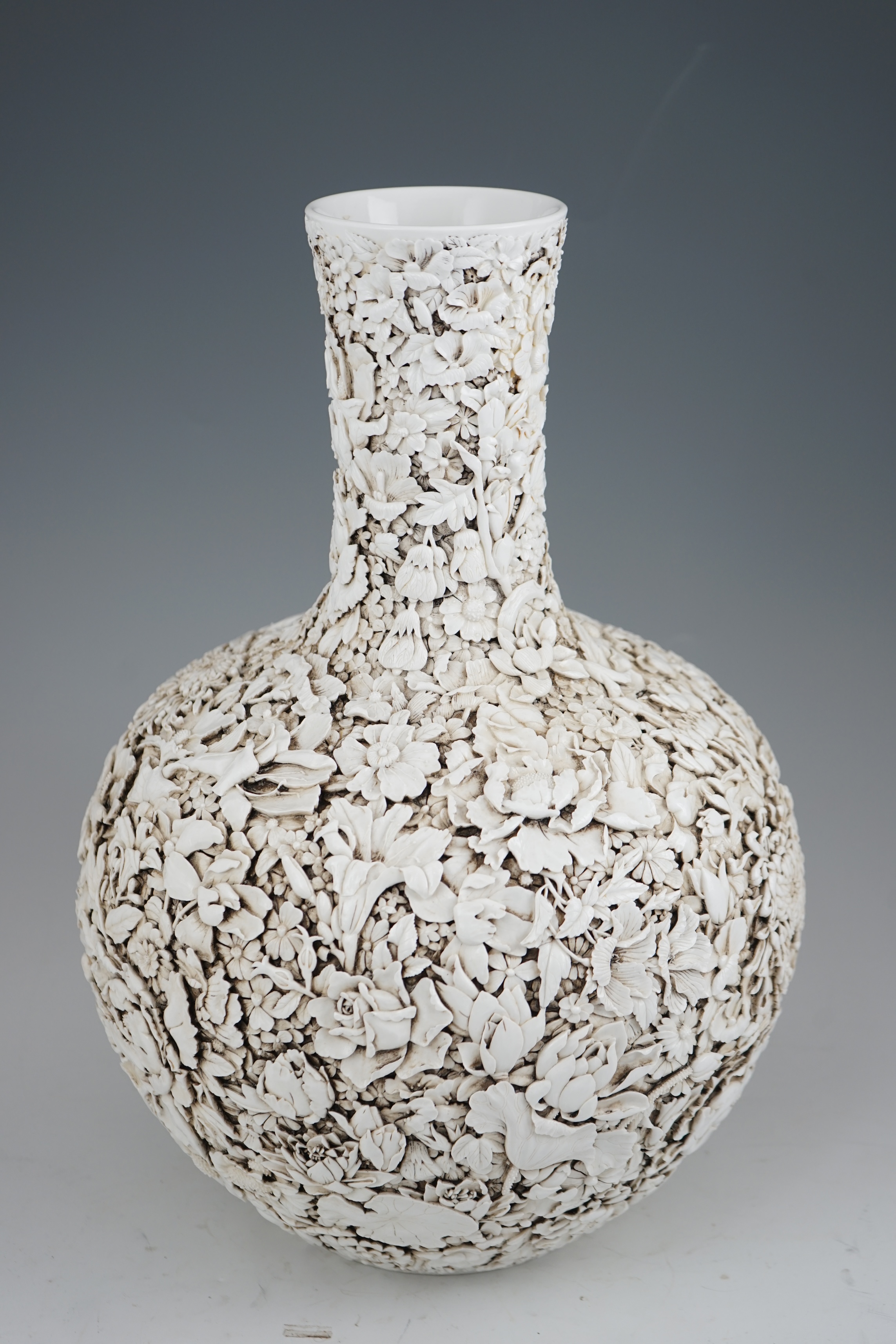 A large Chinese carved porcelain ‘thousand flower’ bottle vase, 20th century